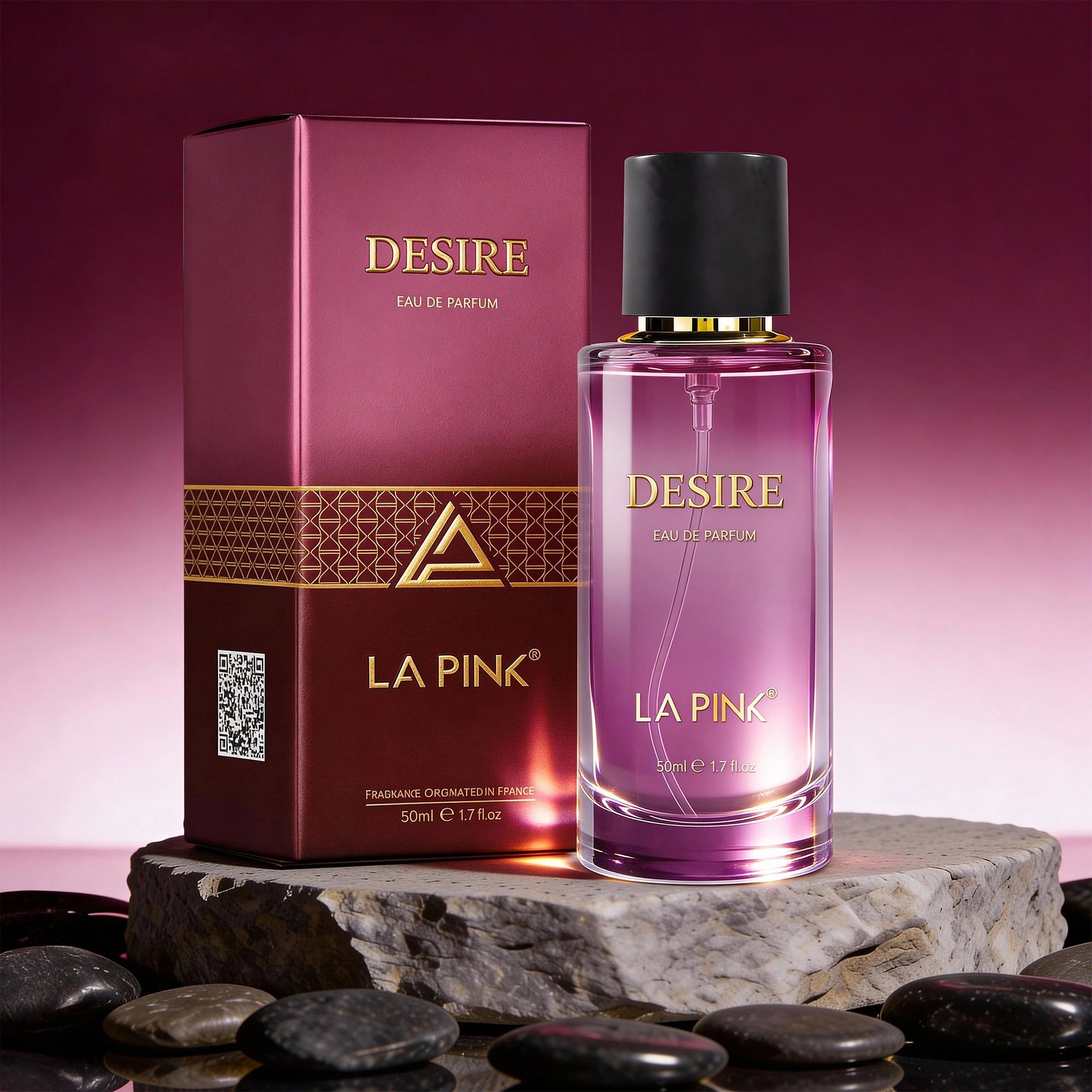 La Pink Desire Eau de Parfum bottle and packaging on a stone surface with a pink gradient background