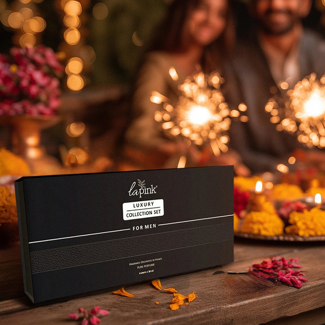 La Pink luxury collection set for men on a wooden table with blurred background of people and lights.