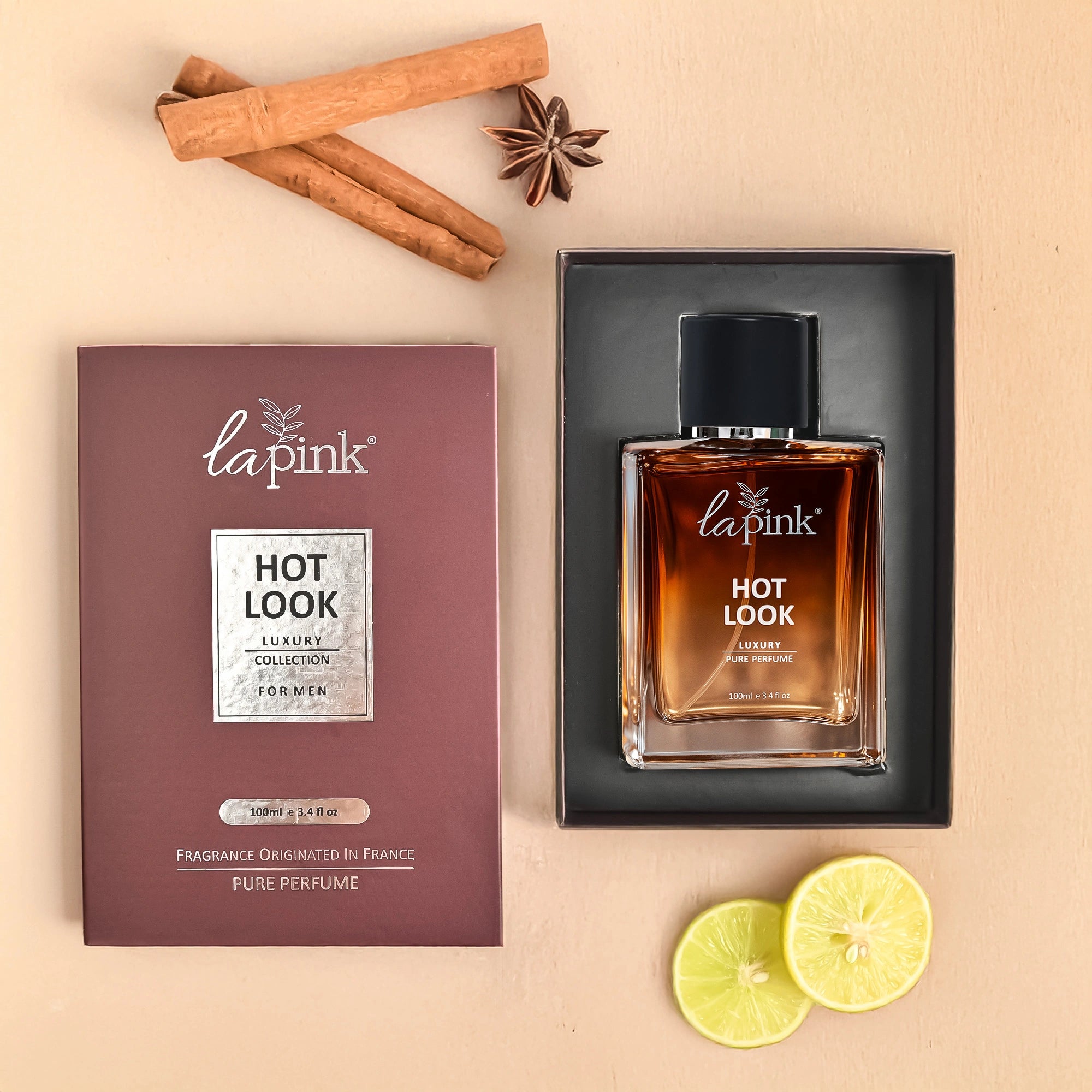 La Pink Hot Look perfume bottle and packaging on a beige background with cinnamon sticks and lime slices.