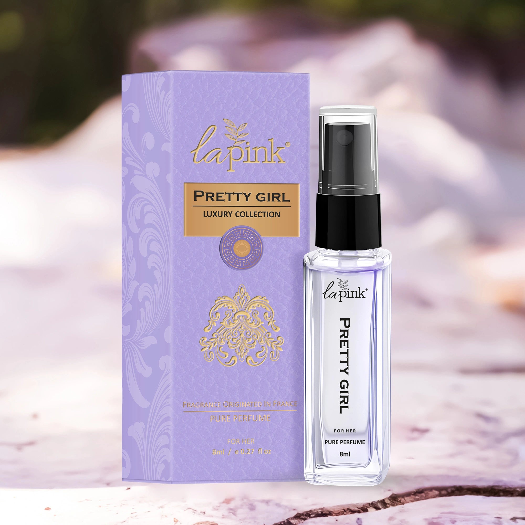 La Pink Pretty Girl perfume bottle and packaging on a marble surface with blurred background