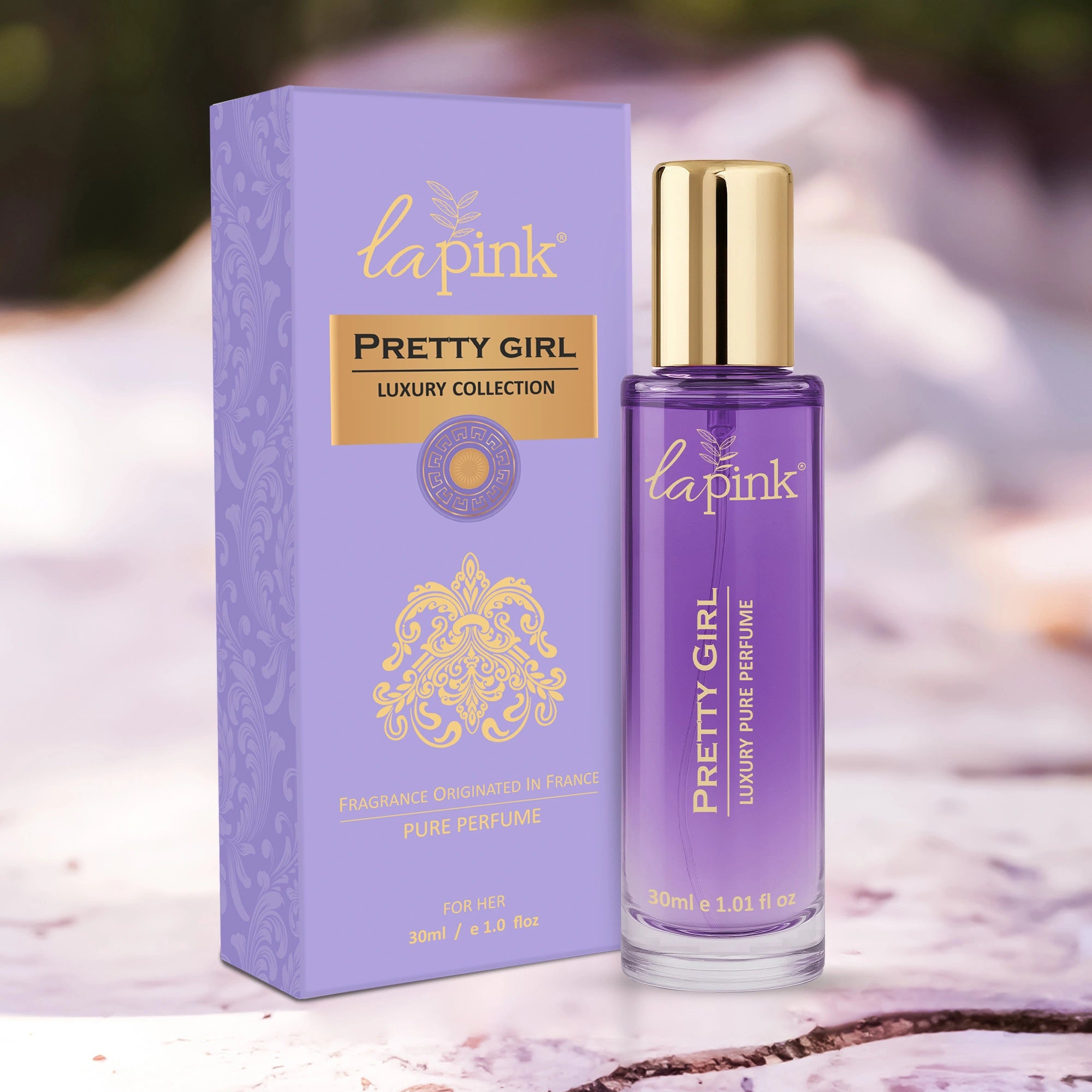 La Pink Pretty Girl perfume bottle and packaging on a marble surface with blurred background