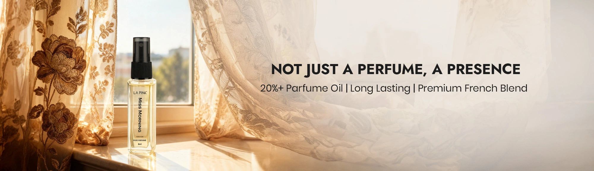 Perfume bottle on a windowsill with decorative plate and floral curtains, featuring text about the product.