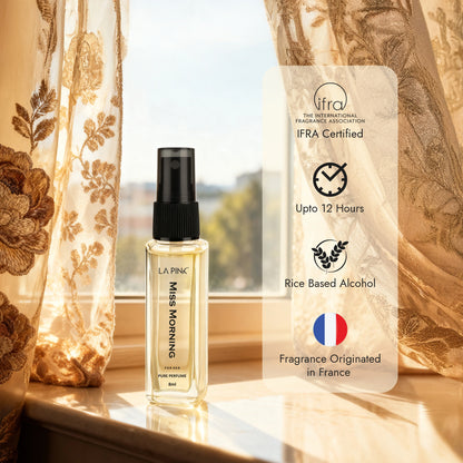 Perfume bottle with product information card on a window sill with curtains