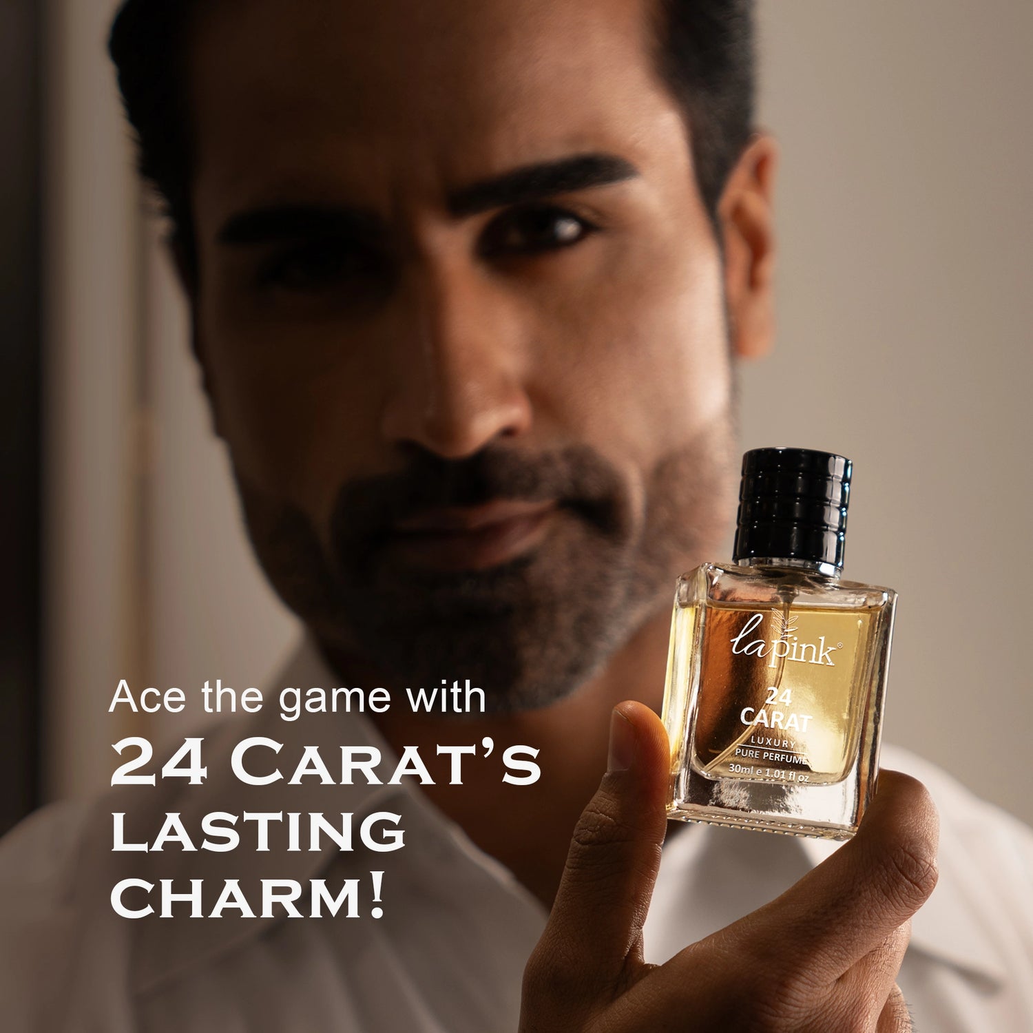 Man holding a perfume bottle with promotional text about &