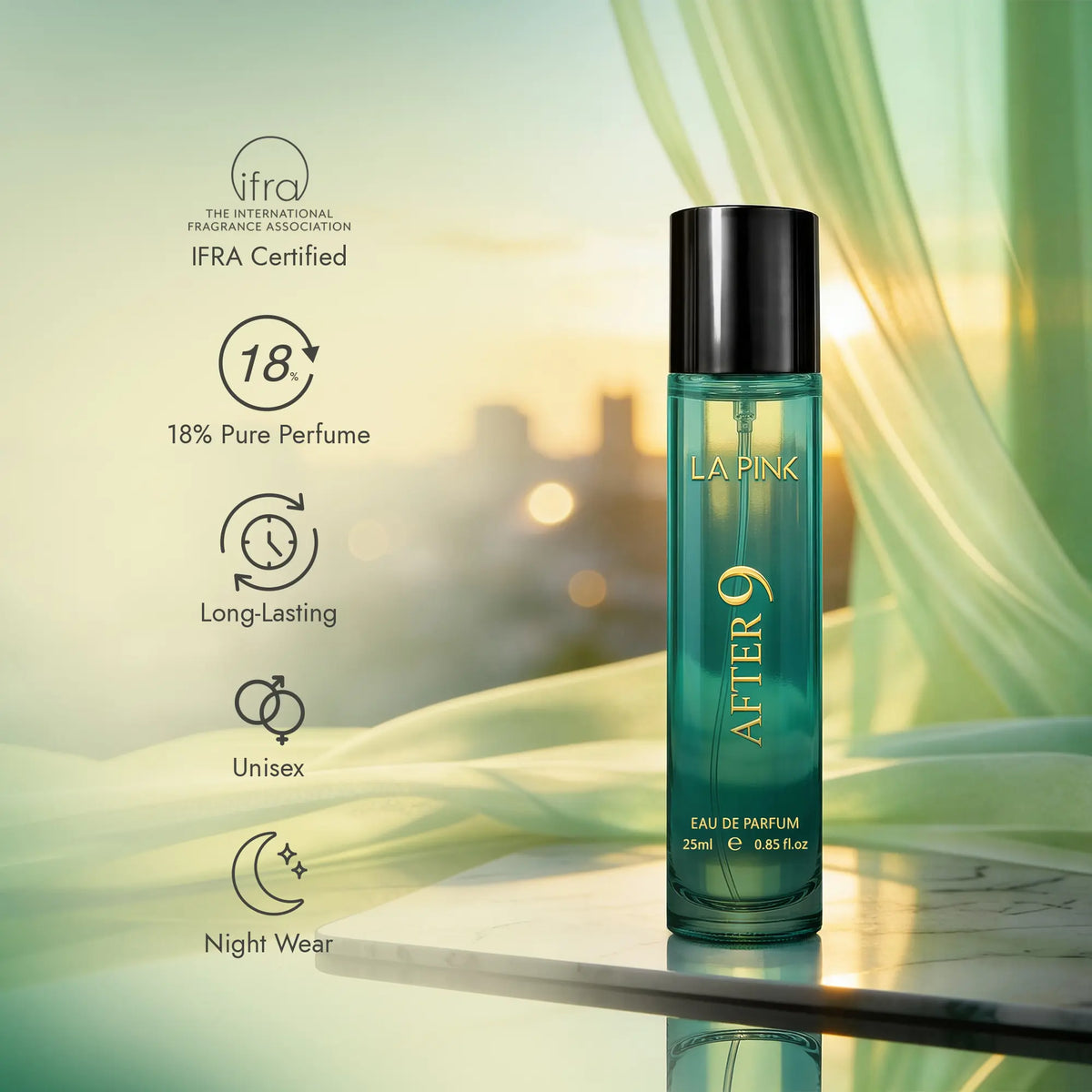 A bottle of LA PINK AFTER 9 Eau de Parfum stands on a reflective surface against a soft-focus background with green drapery and warm sunlight. The bottle is teal with a black cap and gold lettering.

