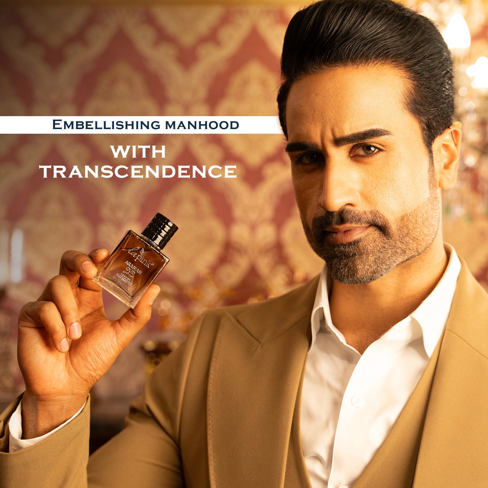 Man holding a perfume bottle with text &