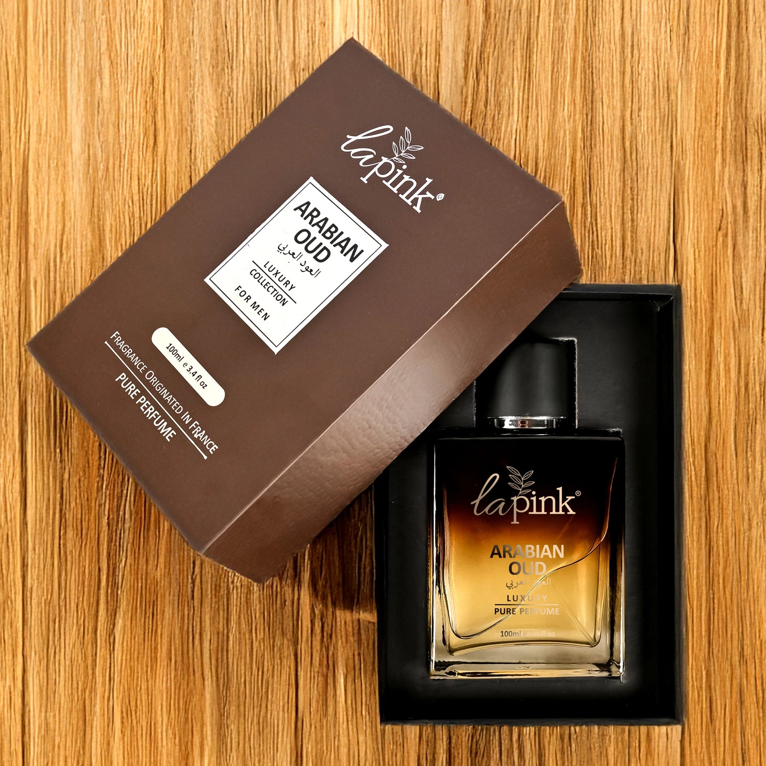 Lapink Arabian Oud perfume bottle and packaging on a wooden surface