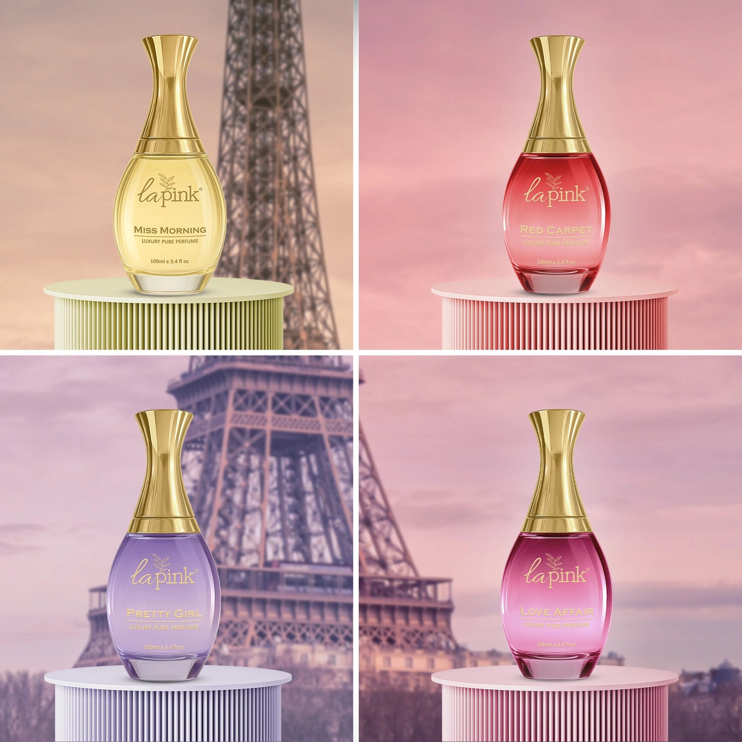 Four different colored perfume bottles with gold caps on a stand against a blurred Eiffel Tower background.