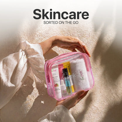 Person holding a pink skincare travel bag with products on a textured surface