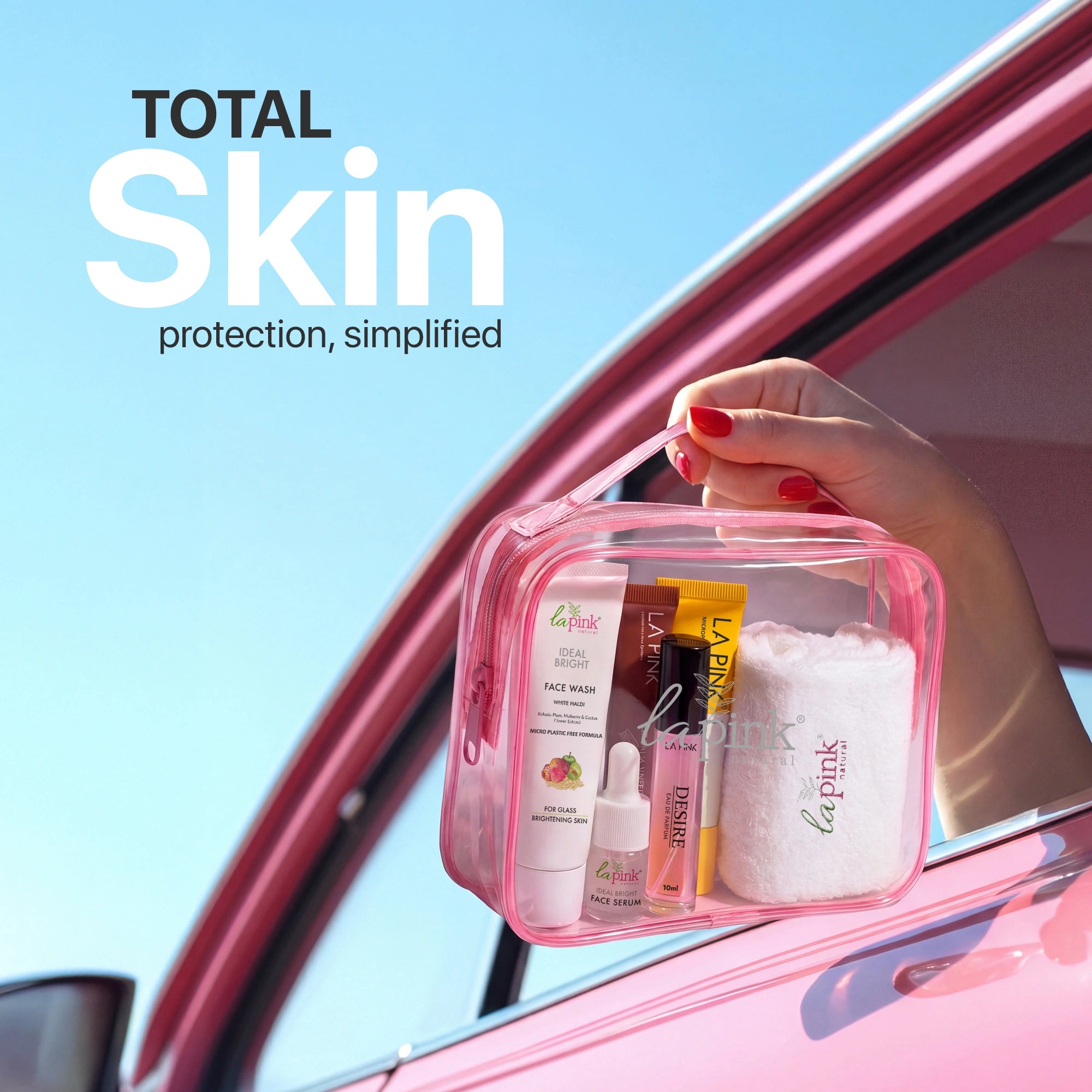 Hand holding a pink skincare kit with &