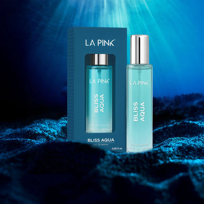 LA Pink Bliss Aqua perfume bottle and packaging on a dark background with blue lighting.