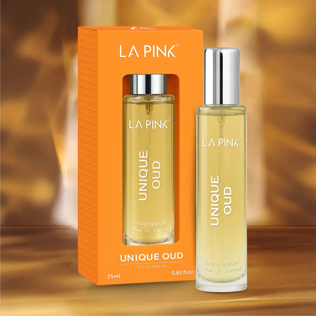 La Pink Unique Oud perfume bottle and packaging on a wooden surface with a blurred background