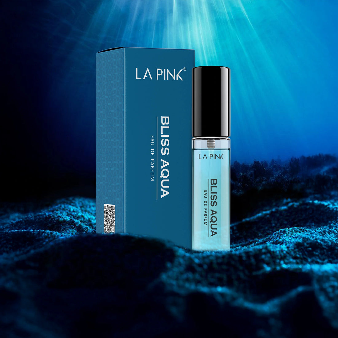 LA Pink Bliss Aqua perfume bottle and packaging on a blue textured background