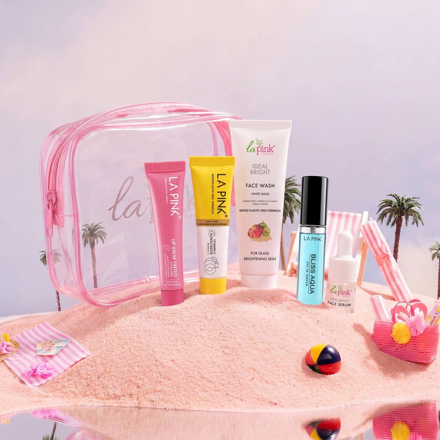 Set of La Pink skincare products with a pink travel bag on a beach-themed background
