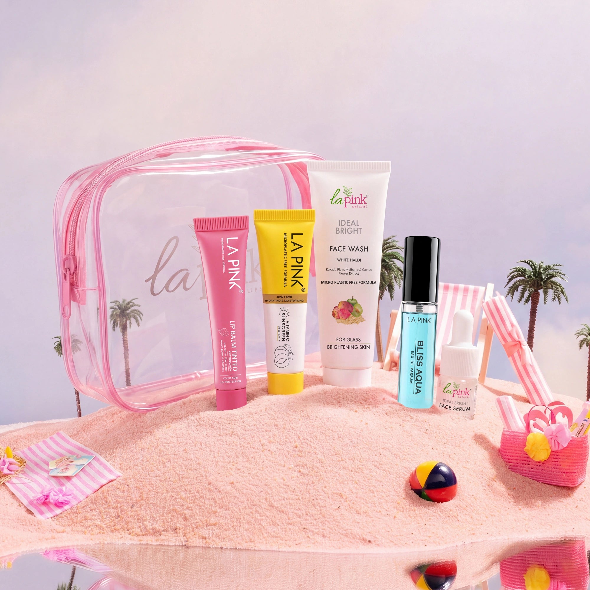 Set of La Pink skincare products with a pink travel bag on a beach-themed background