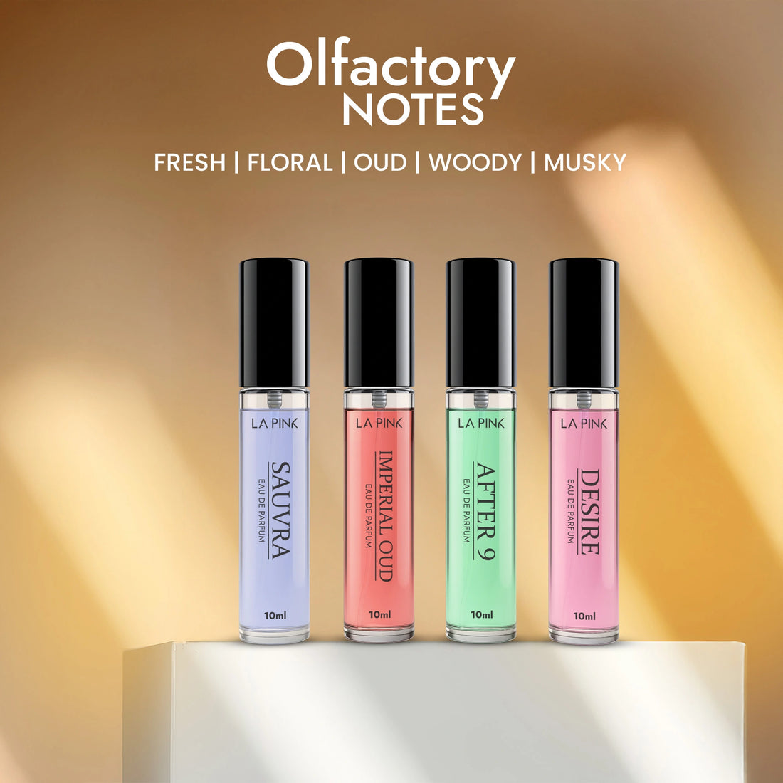 Four small bottles of perfume with different colored labels on a light background, featuring the brand &