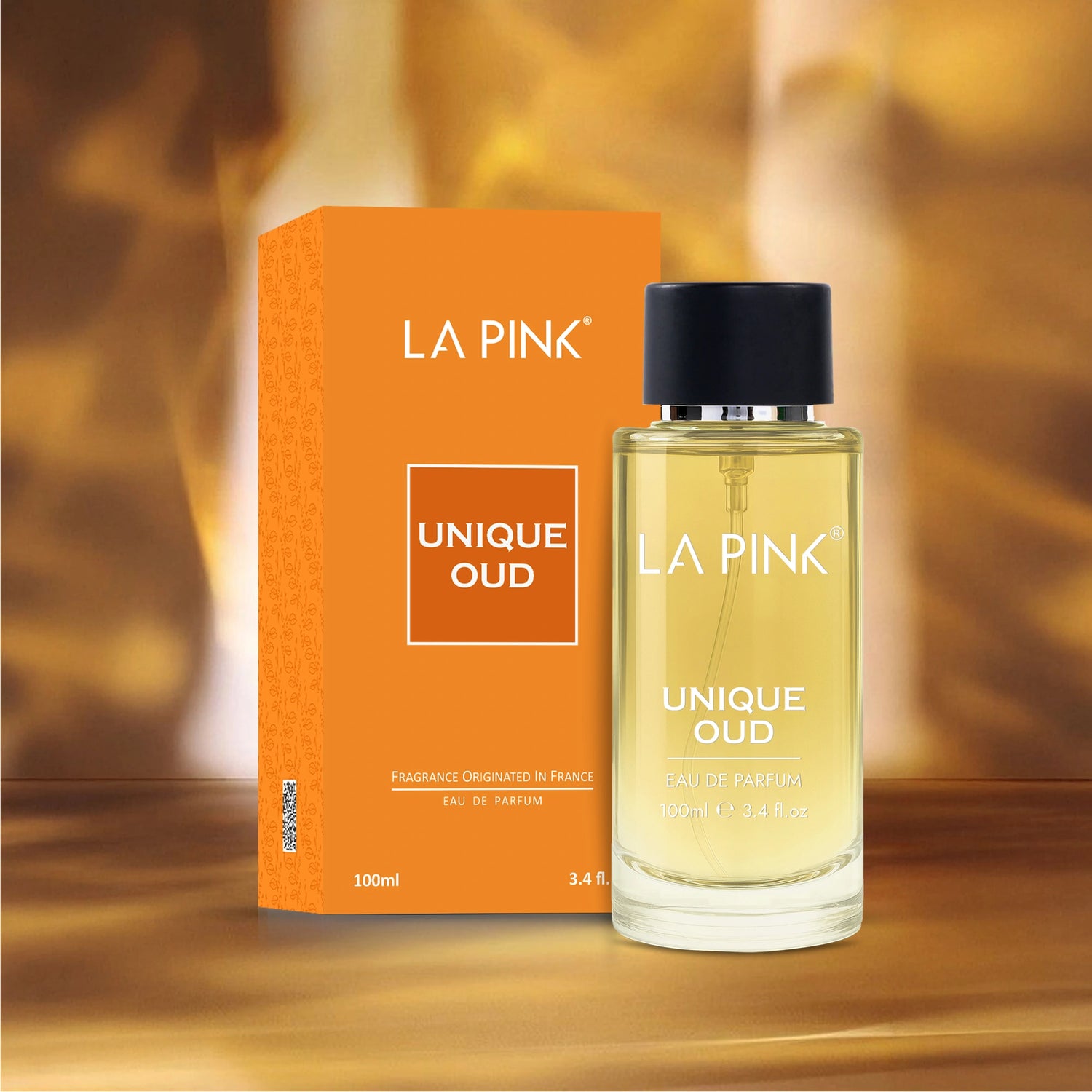 La Pink Unique Oud perfume bottle and packaging on a wooden surface with a blurred background