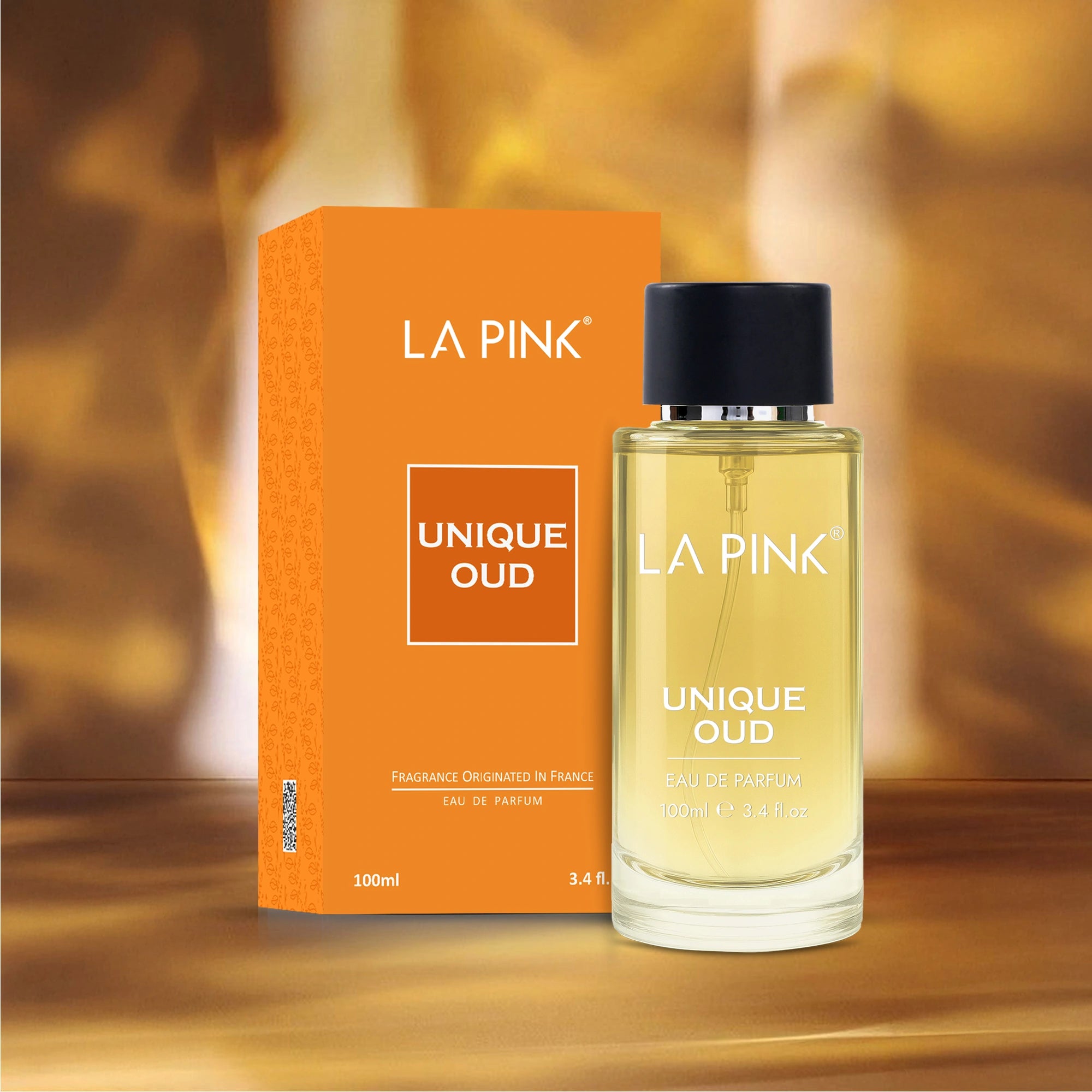 La Pink Unique Oud perfume bottle and packaging on a wooden surface with a blurred background