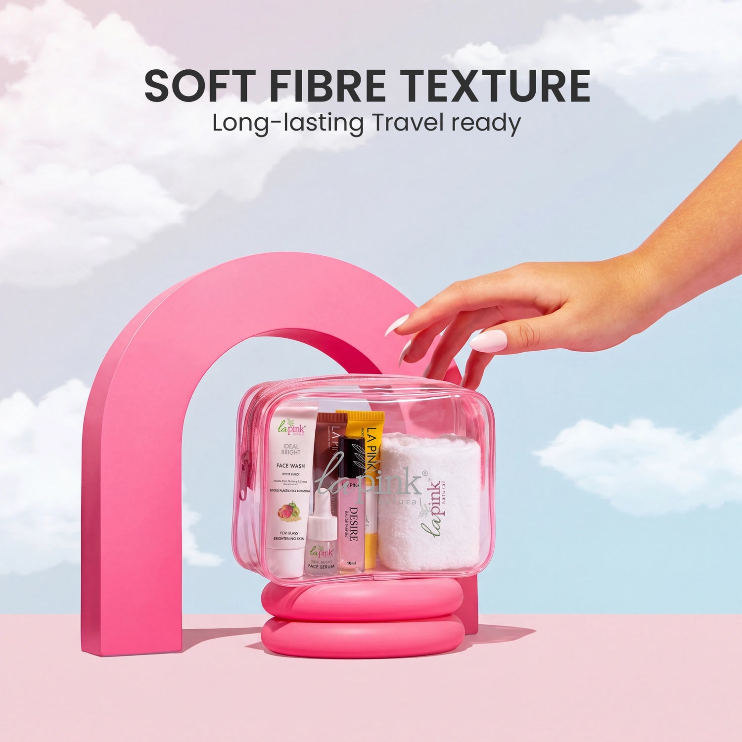 Pink travel organizer with skincare products against a sky background