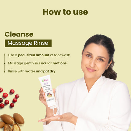 Woman holding a face wash tube with instructions on how to use it on a light green background