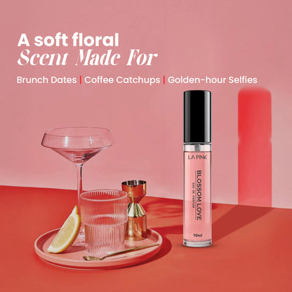 Pink lip gloss bottle on a red surface with a glass and lemon wedge, against a pink background.