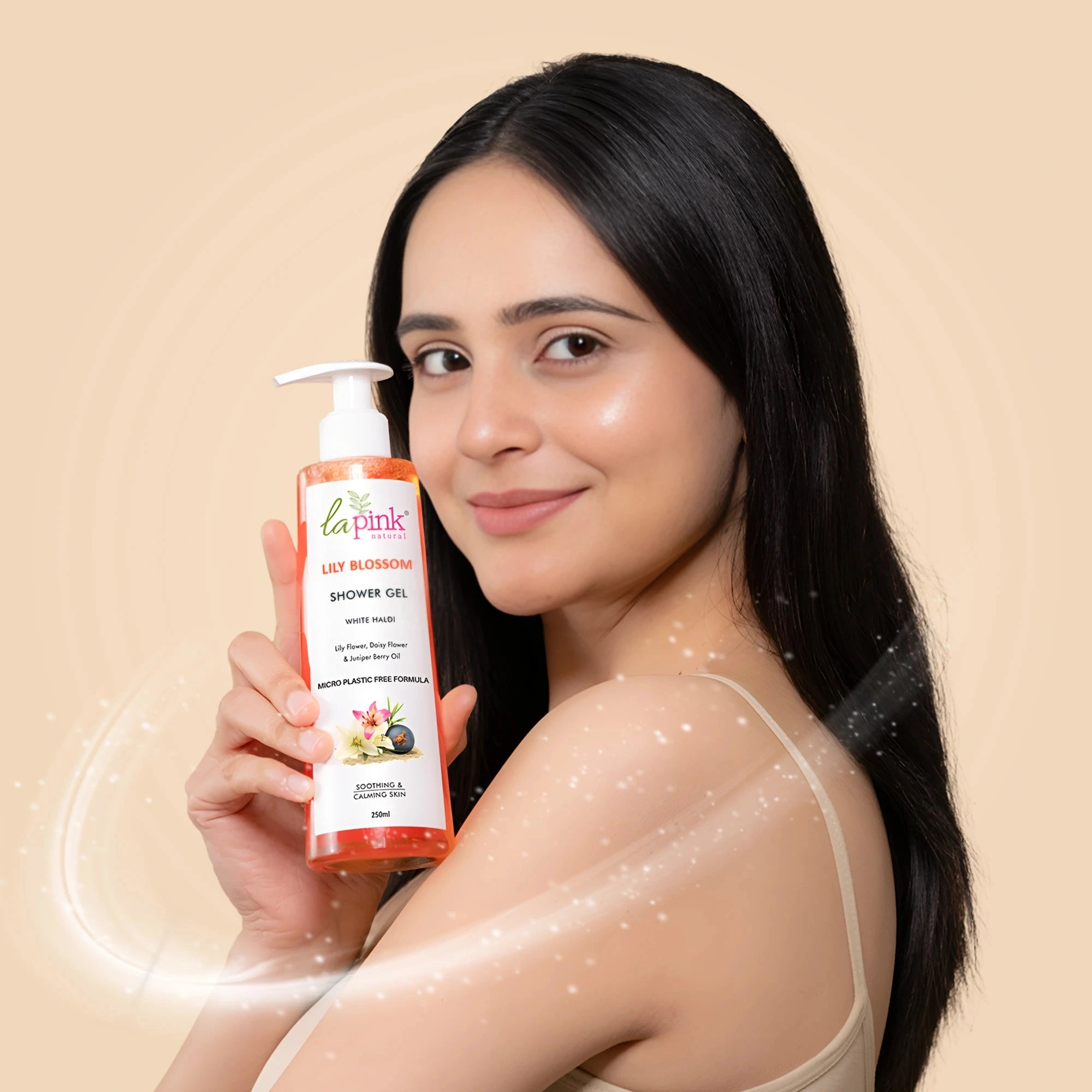 Woman holding a bottle of La Pink shower gel with a beige background