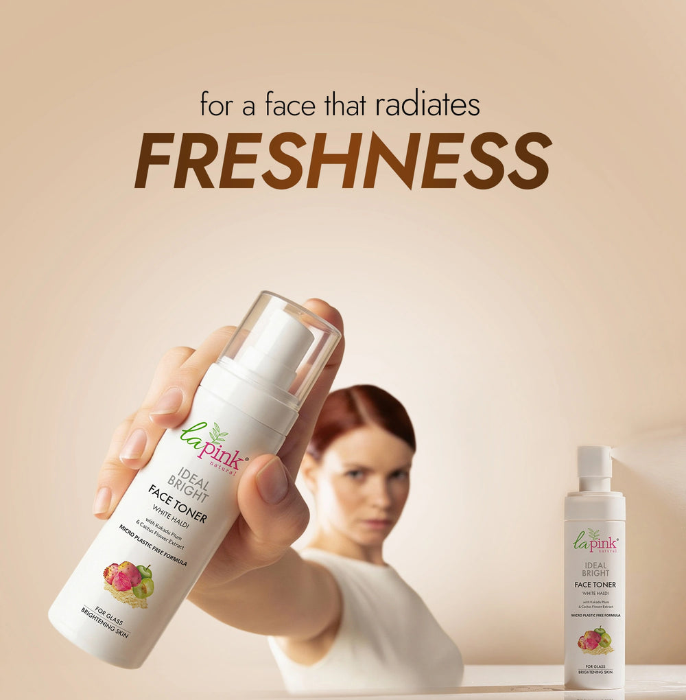 Hand holding a bottle of La Pink Ideal Bright Face Toner with a woman in the background and text 'for a face that radiates FRESHNESS'.