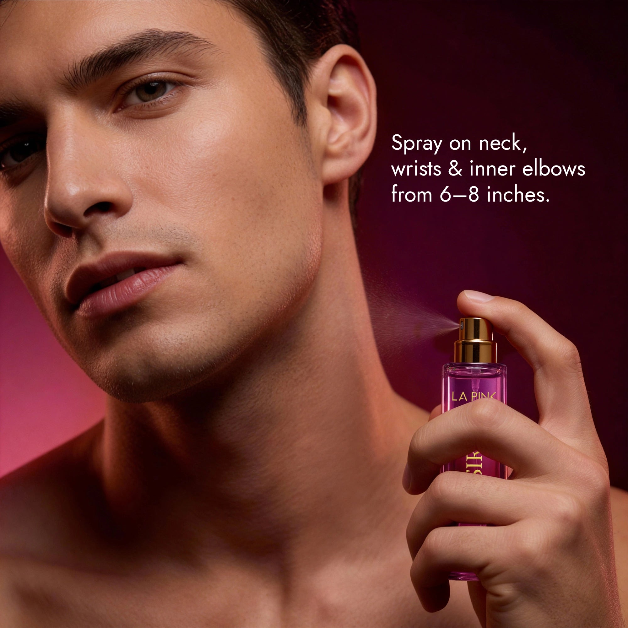 Man holding a perfume bottle with spray instructions on a pink background