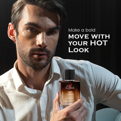 Man holding a perfume bottle with text &
