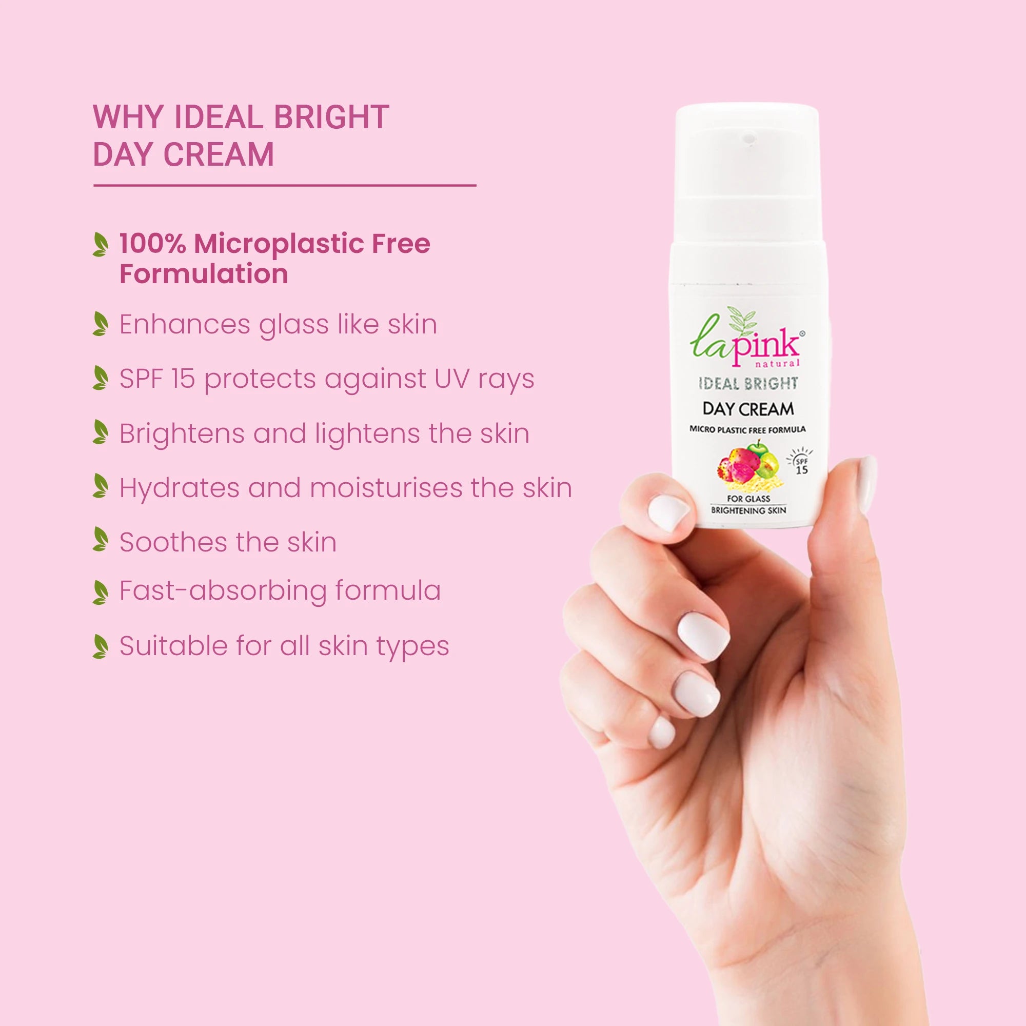 Hand holding a bottle of La Pink Ideal Bright Day Cream with product details on a pink background