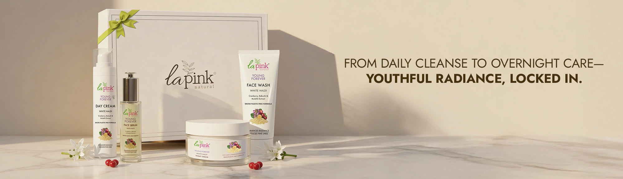 Cosmetic products with packaging on a neutral background, featuring the brand 'La Pink'.