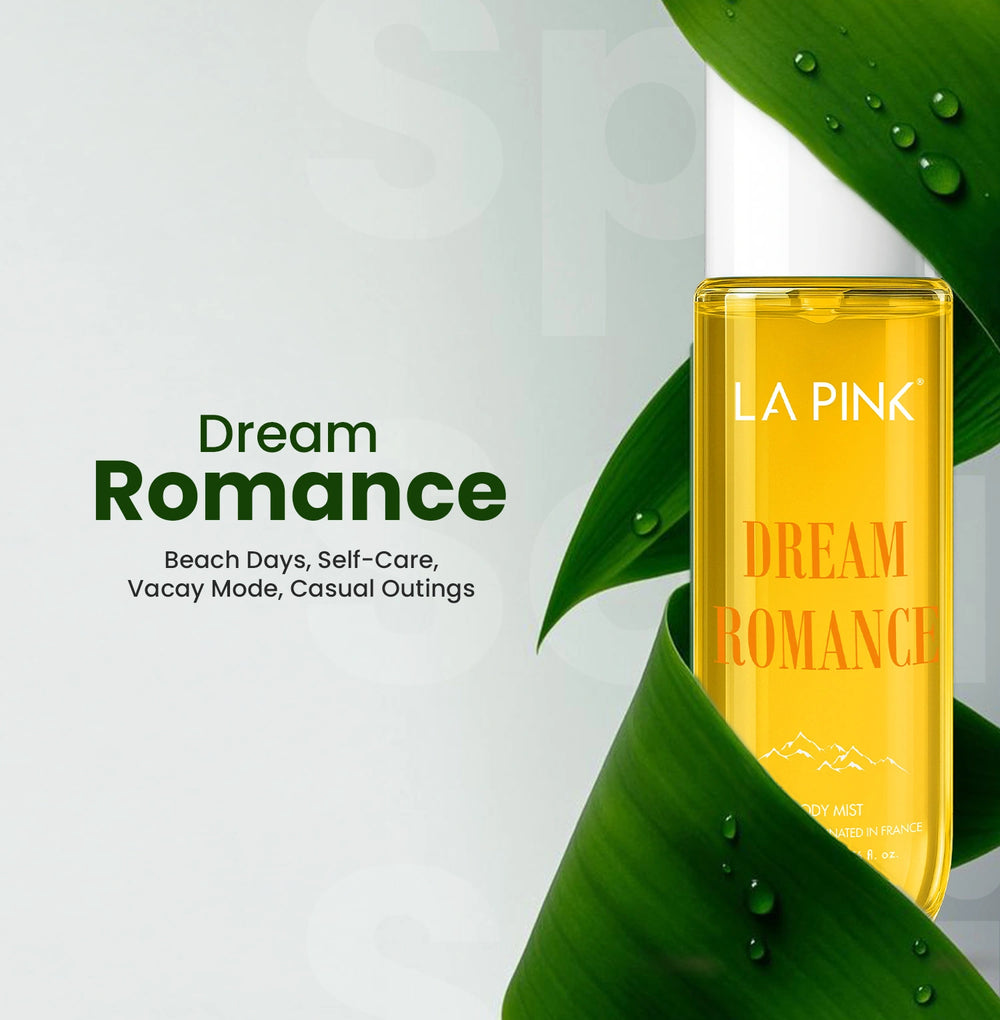 Yellow bottle of LA PINK Dream Romance perfume on a green leaf with a light gray background
