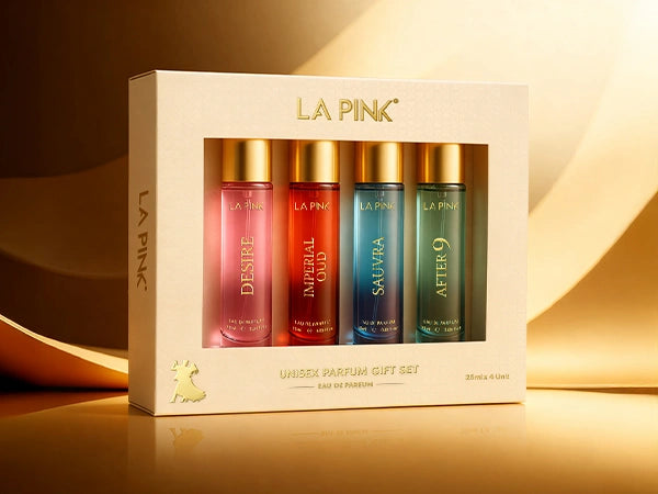 LA Pink perfume gift set with four bottles in a box on a reflective surface.