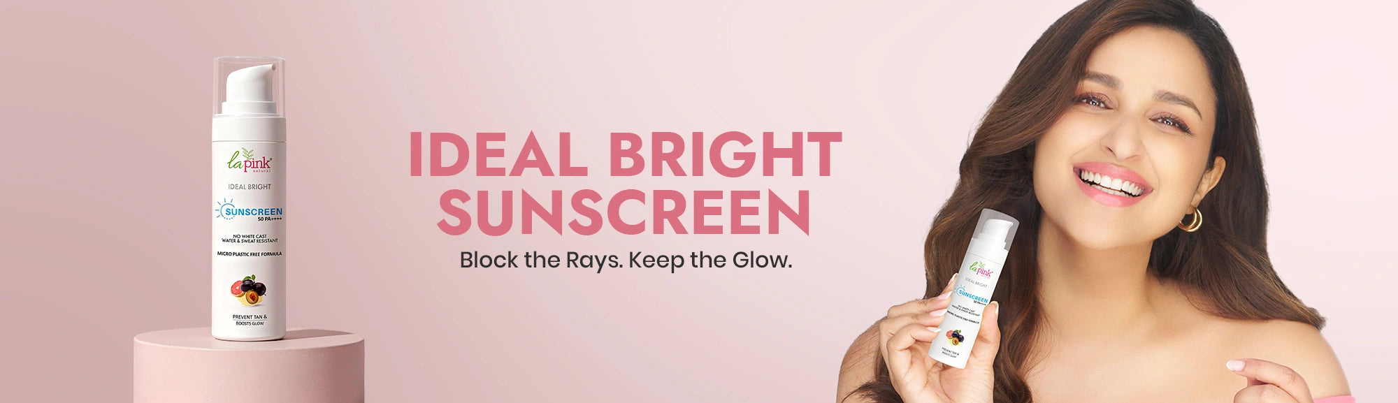 Ideal Bright sunscreen with a model holding the product against a pink background
