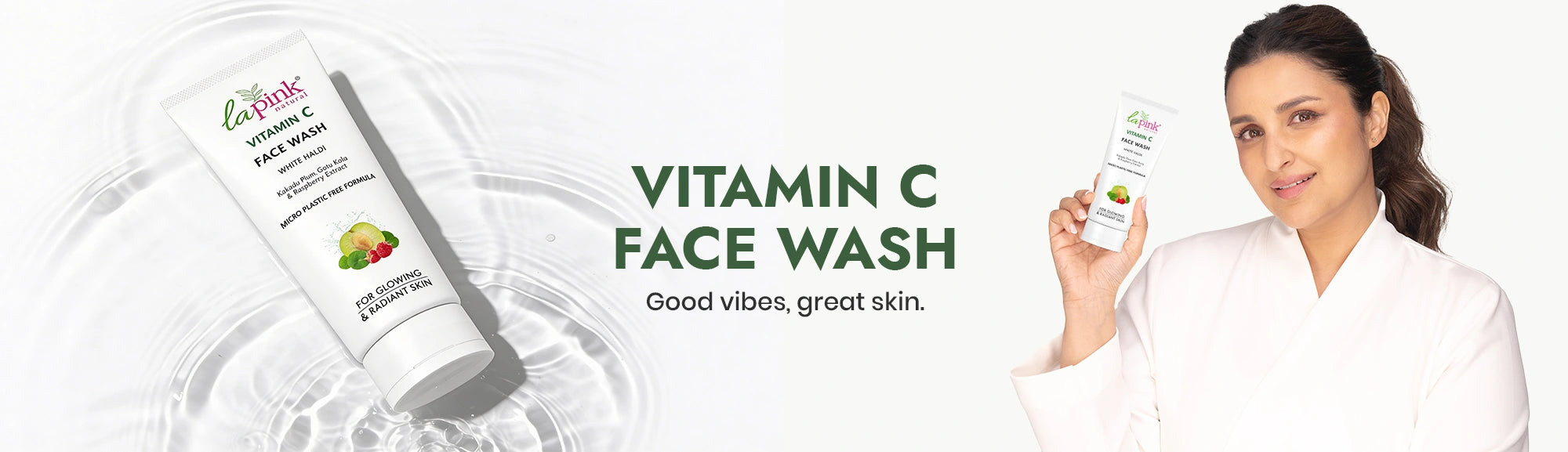 Woman holding a bottle of Vitamin C Face Wash with product packaging and branding elements.