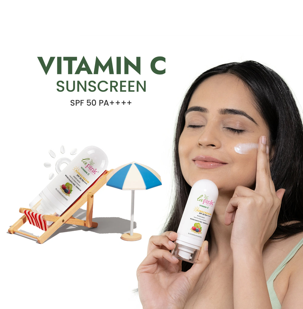 Woman applying sunscreen with a bottle of vitamin C sunscreen on a white background