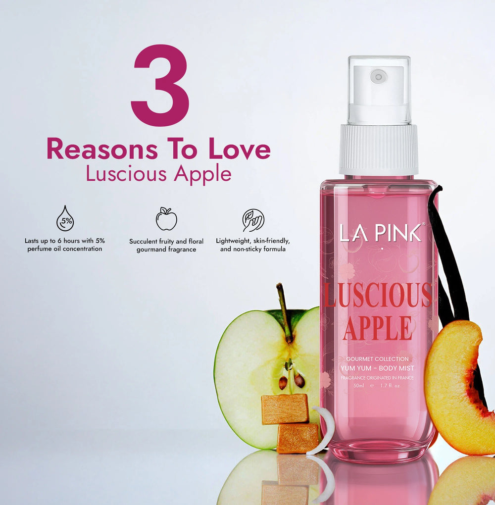 Pink bottle of LA Pink Luscious Apple perfume with apple slices on a light gray background