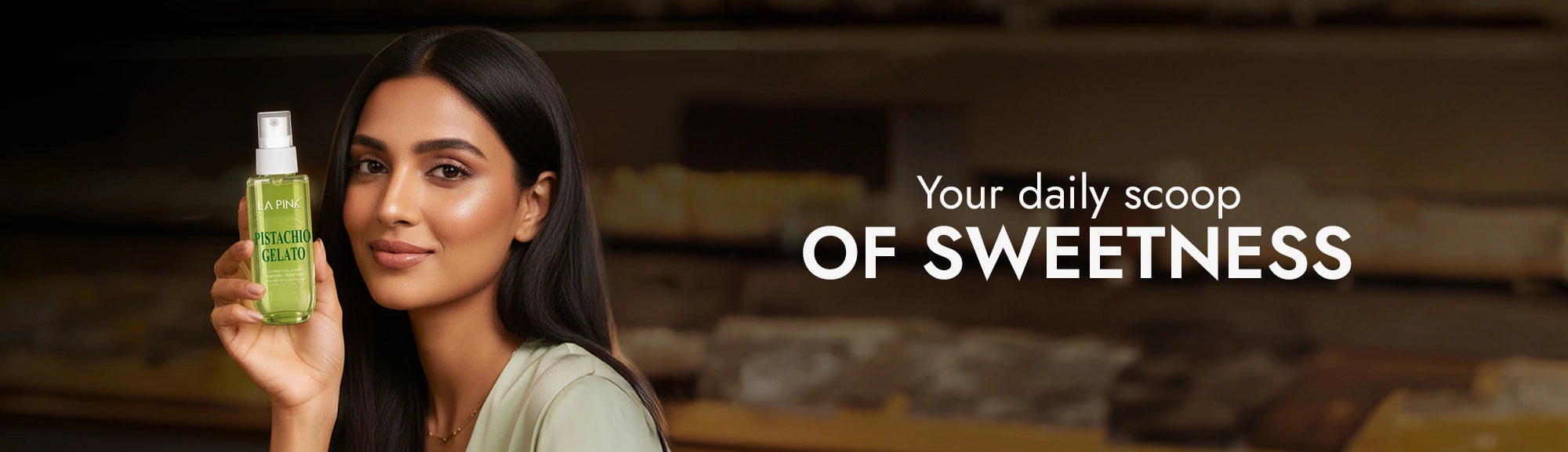 Woman holding a green bottle with text 'Your daily scoop of sweetness' on a blurred background