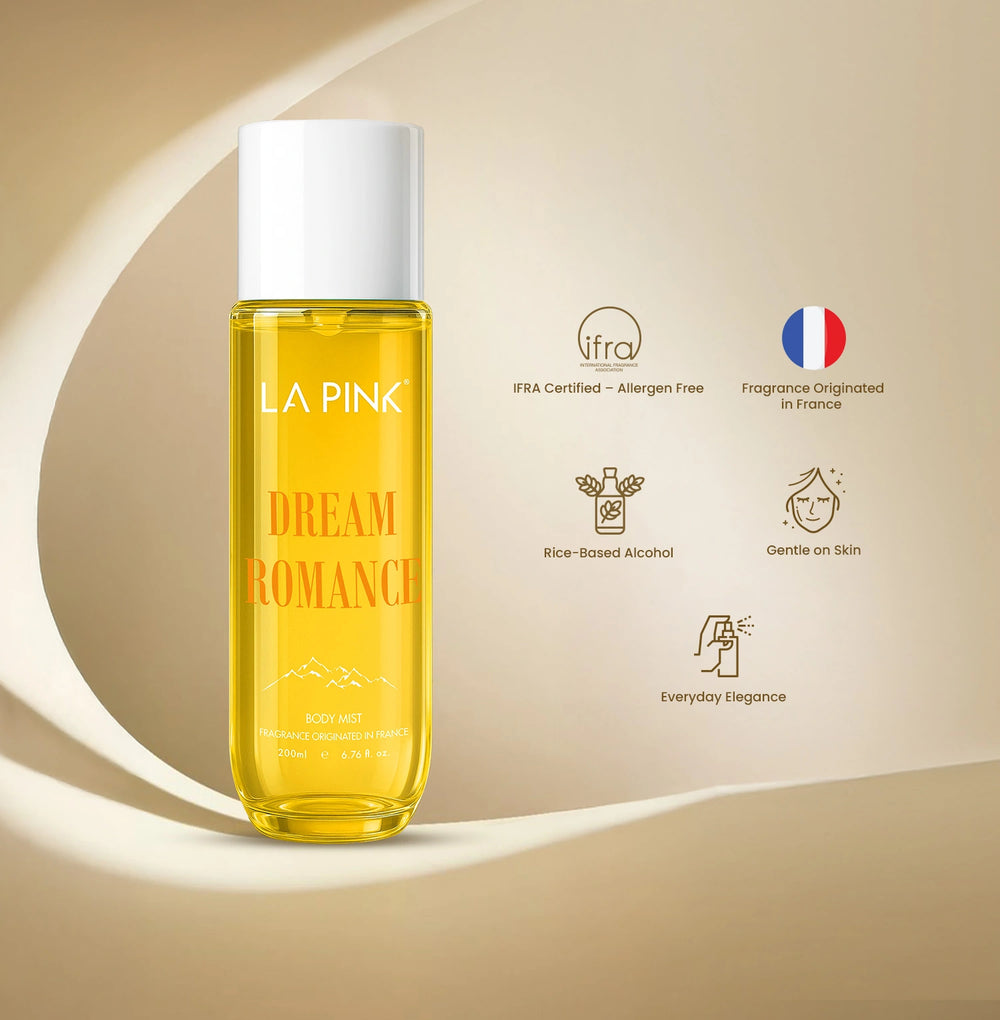 Yellow bottle labeled 'LA PINK Dream Romance' on a beige background with brand icons.