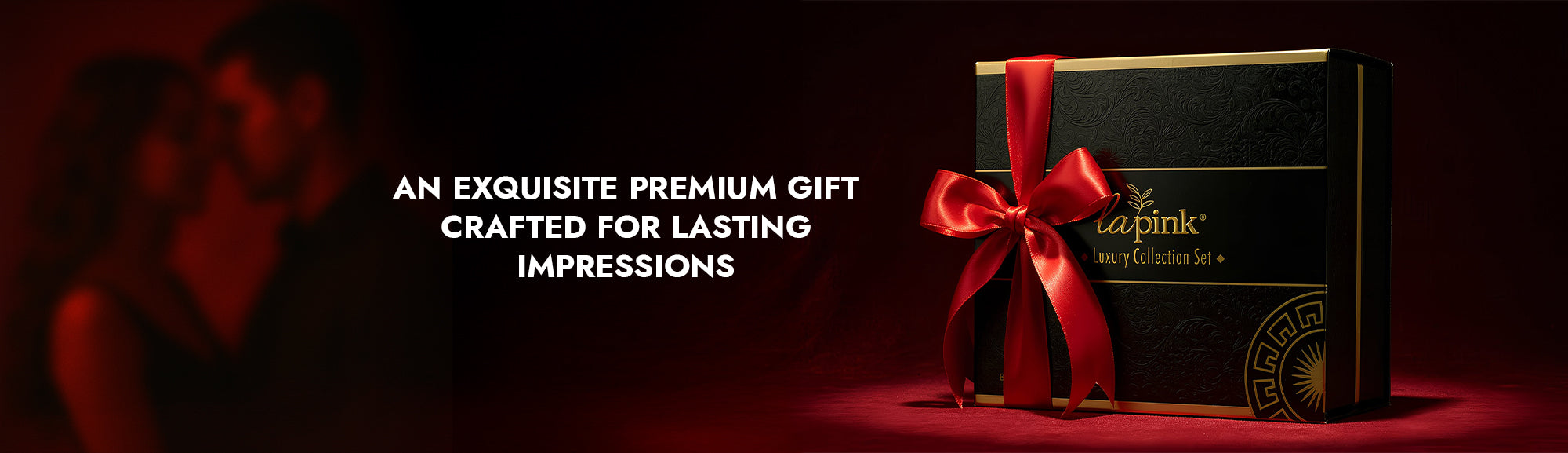 Black gift box with red ribbon on a dark background, featuring the Caprice Pink brand.