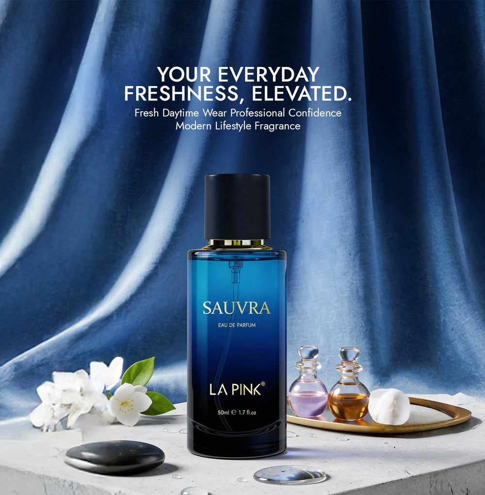 Sauvra perfume bottle with flowers and other bottles on a blue draped background