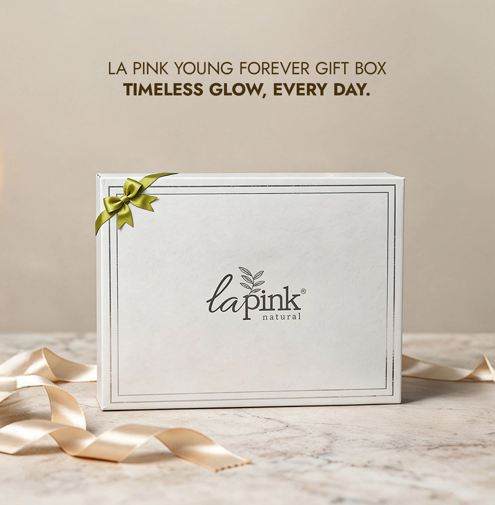 White gift box with green ribbon and 'la pink natural' branding on a beige background.
