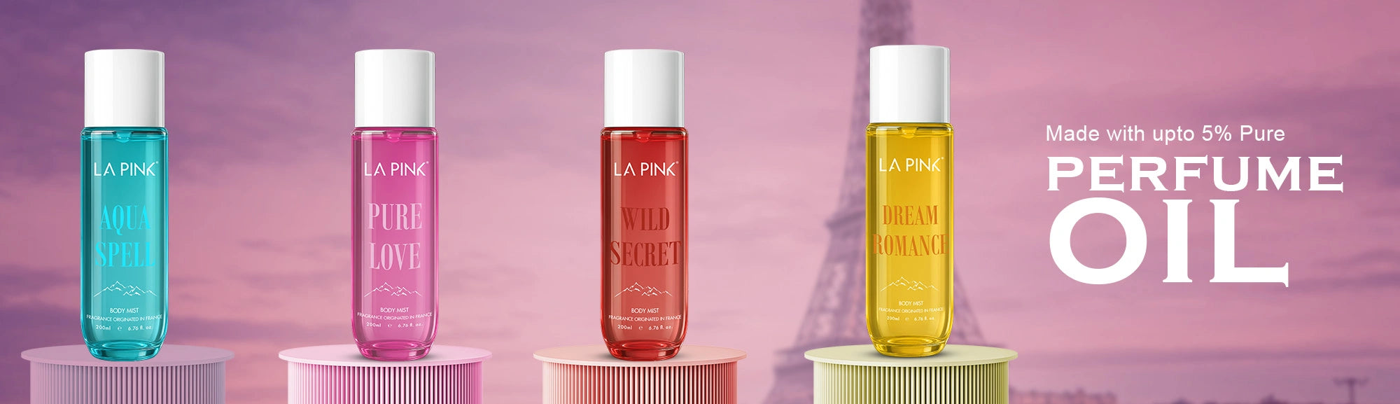Four La Rive perfume oils on stands with a pink background