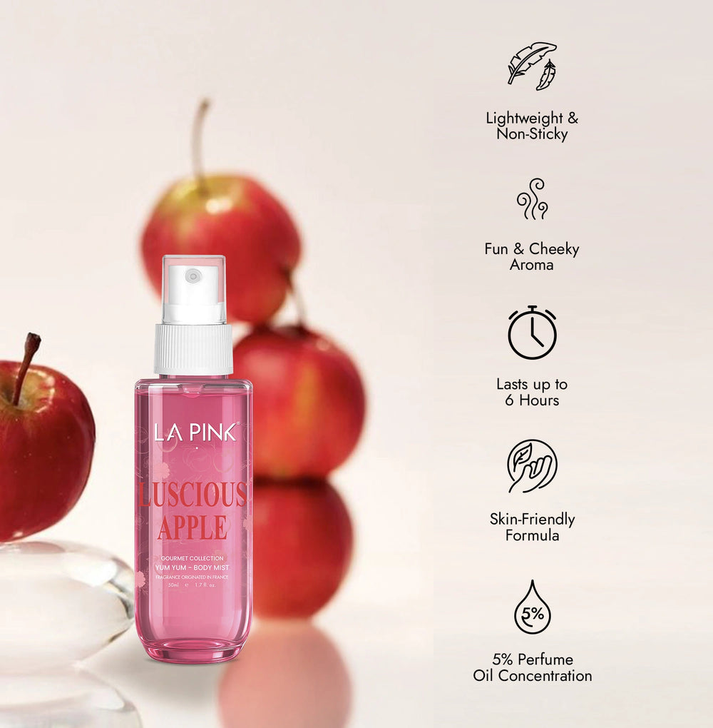 Pink perfume bottle with apples on a light background