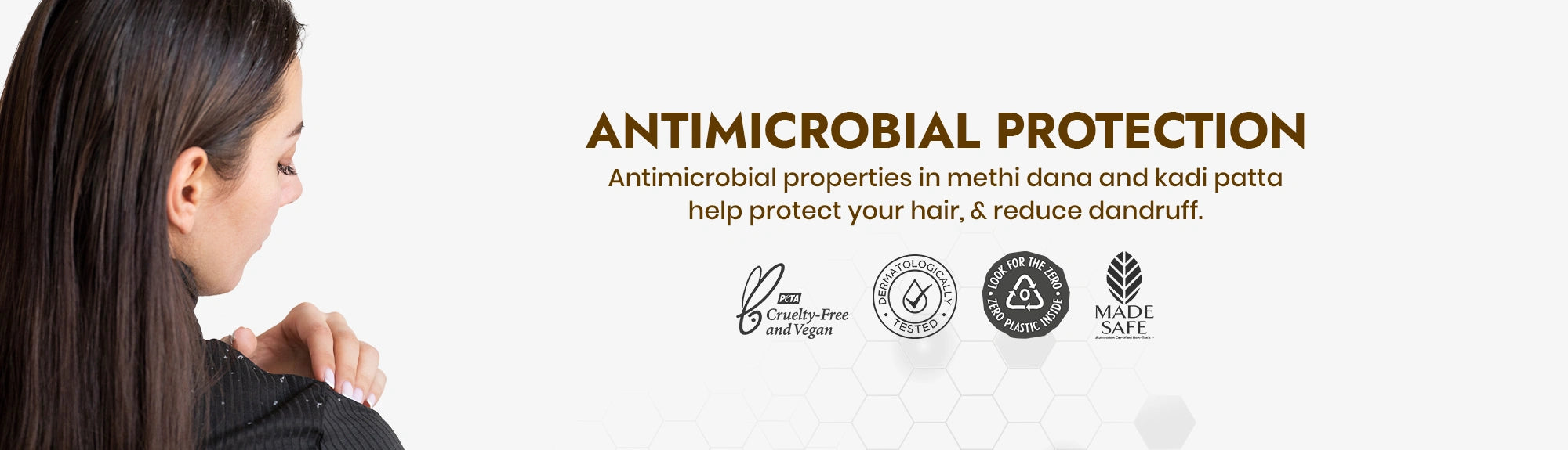 Woman with long hair looking at herself in a mirror, with text about antimicrobial protection and brand logos.