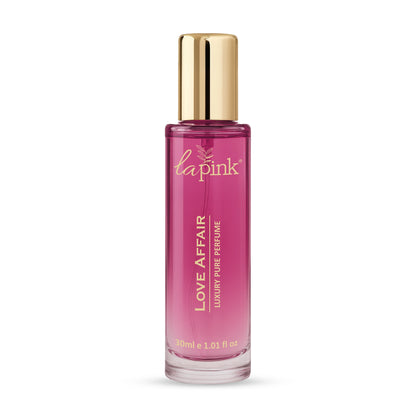 Pink perfume bottle with gold cap on a white background