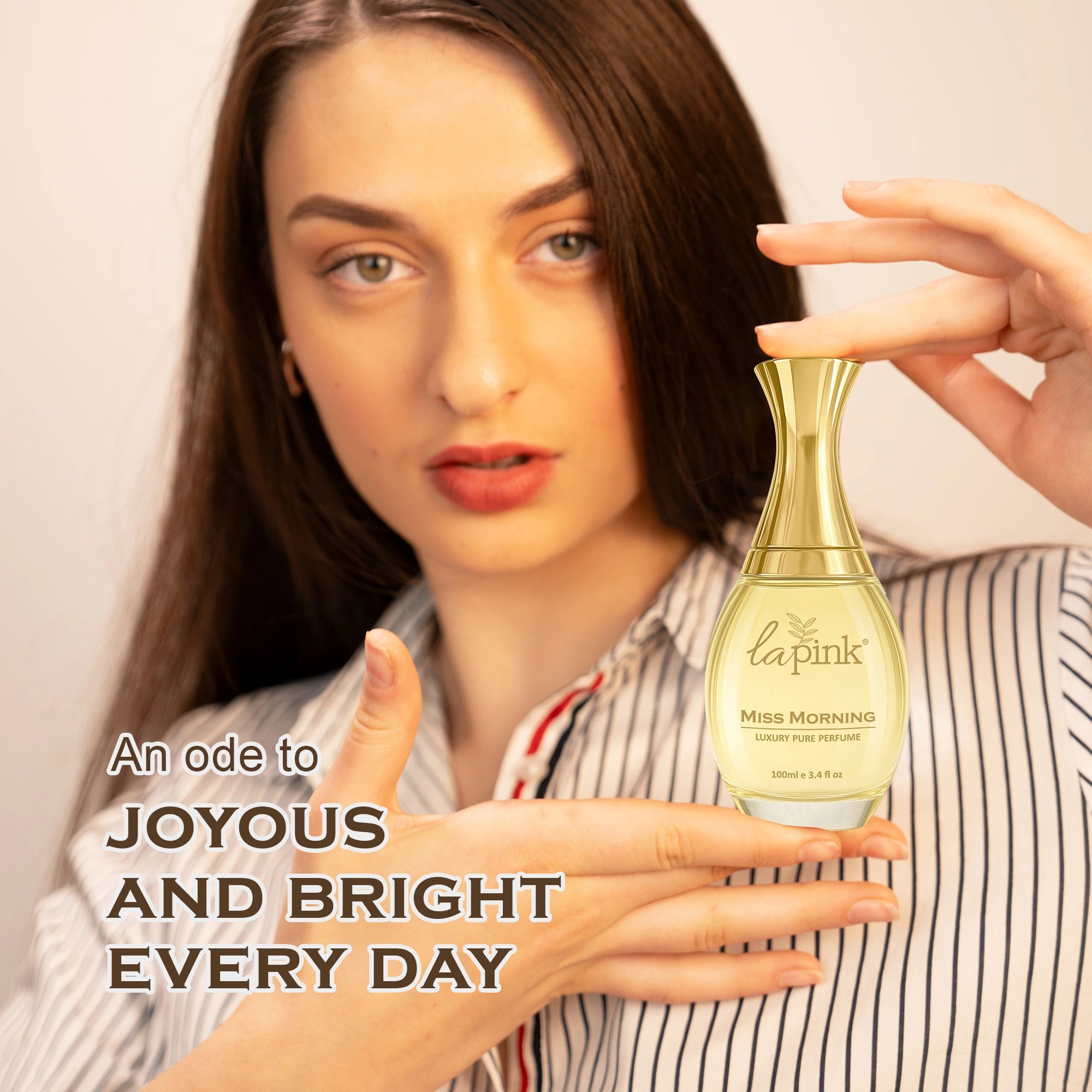 Woman holding a perfume bottle with text about joy and brightness