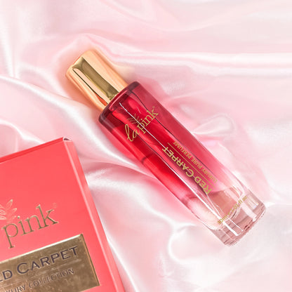 Red lip gloss with gold cap on a pink satin background