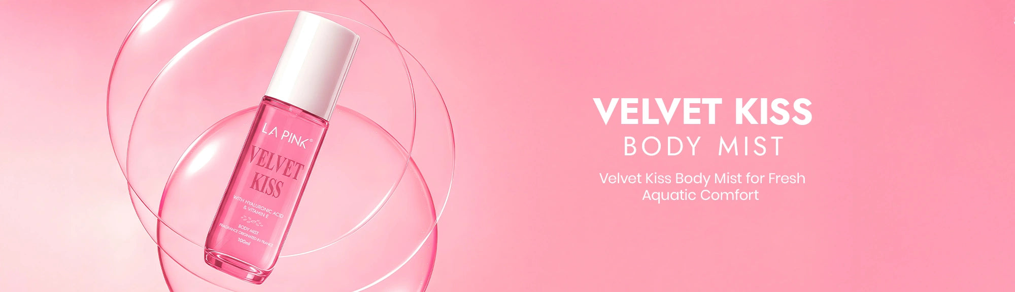 Body mist bottle labeled 'Velvet Kiss' on a pink background