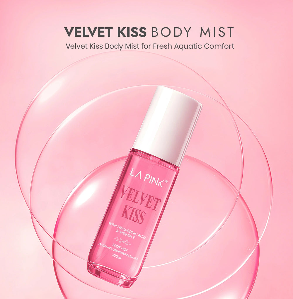 Pink bottle of 'Velvet Kiss' body mist with a white cap on a pink background